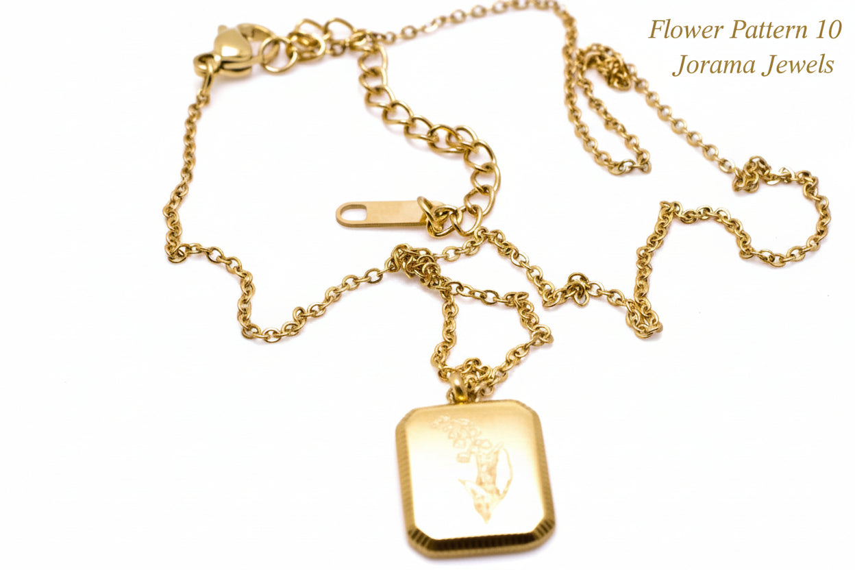 Gold necklace with a square pendant on a light white background
