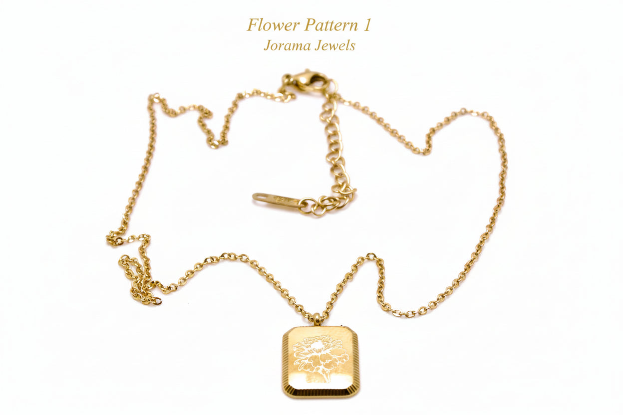 Gold necklace with a square pendant on a light white background