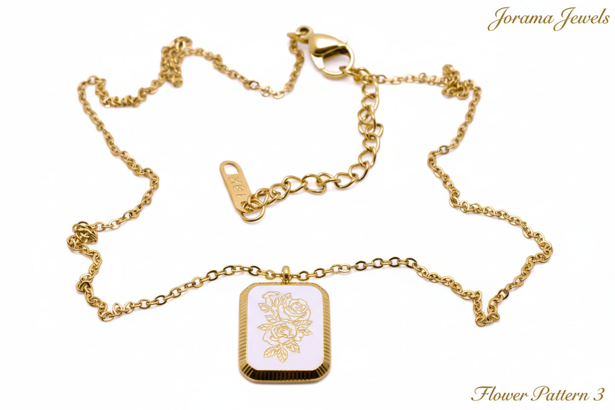 Gold necklace with a rectangular pendant on a light white background