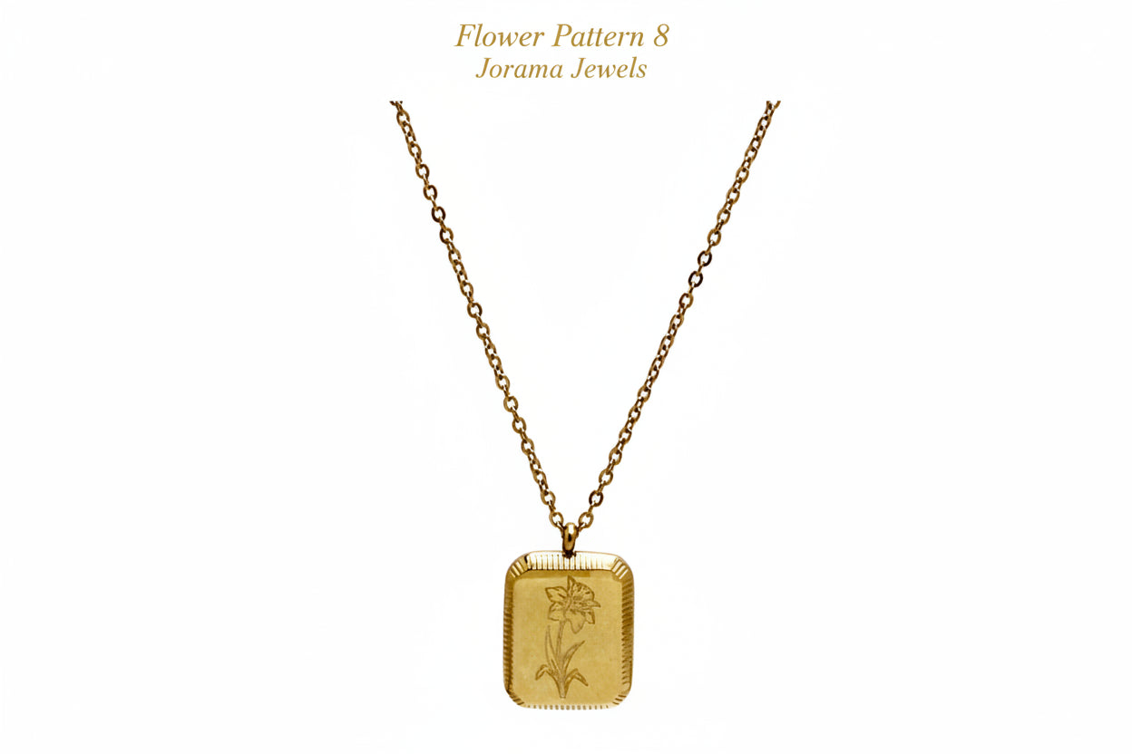 Gold necklace with a rectangular pendant on a light purple background