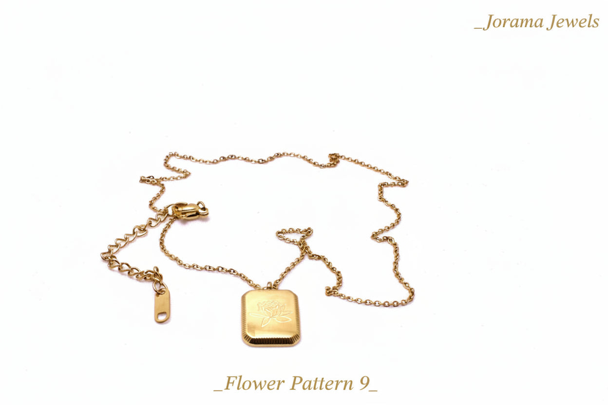 Gold necklace with a tag on a light pink background