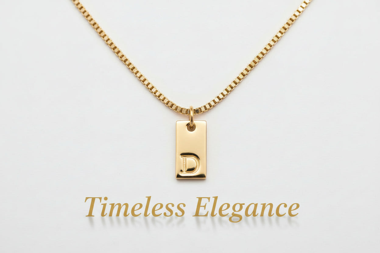 A gold-colored pendant necklace with a chain and a custom name letter pendant.