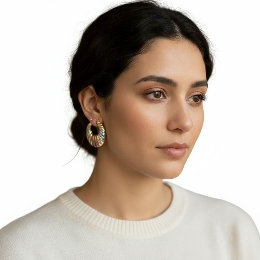 Woman wearing gold hoop earrings with a blurred background