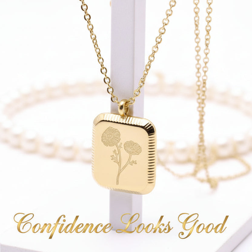 A gold-colored square flower pendant necklace displayed against a white background.
