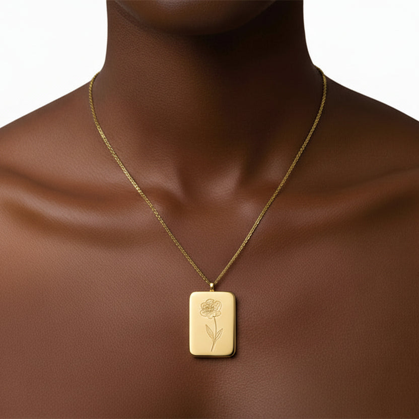 A gold-colored square flower pendant necklace displayed against a white background.