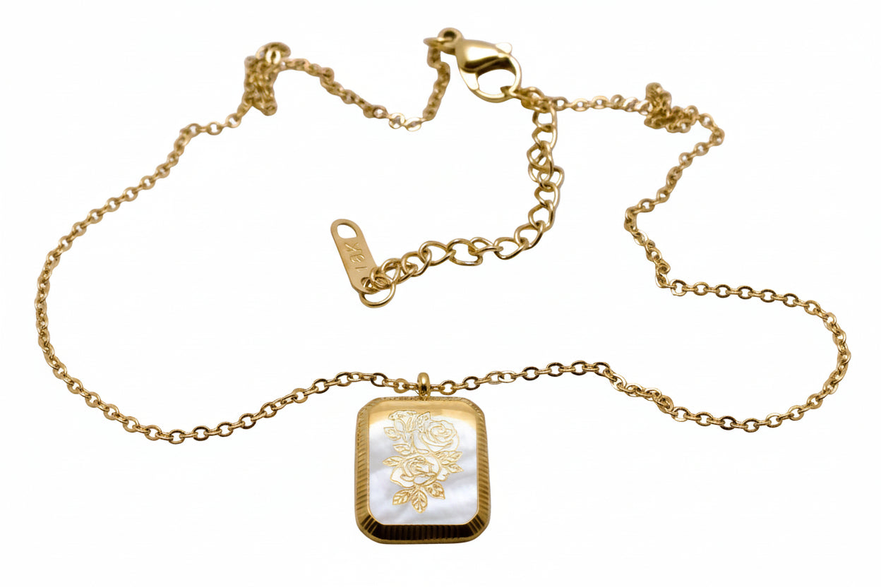 A gold-colored square flower pendant necklace displayed against a white background.
