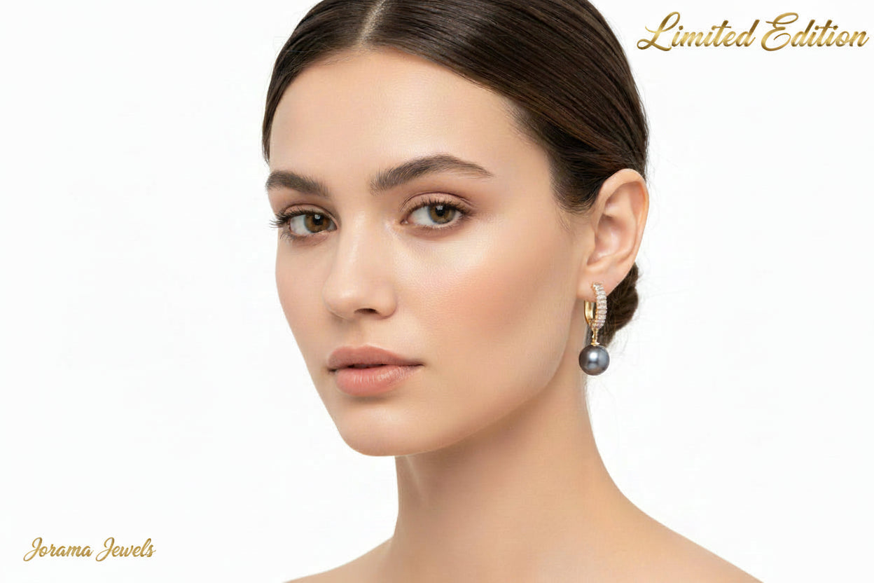 Pair of earrings with black pearls on a white background