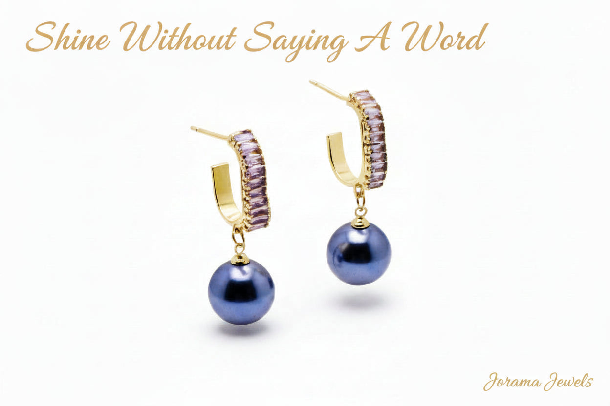 Pair of earrings with blue beads on a light gray background
