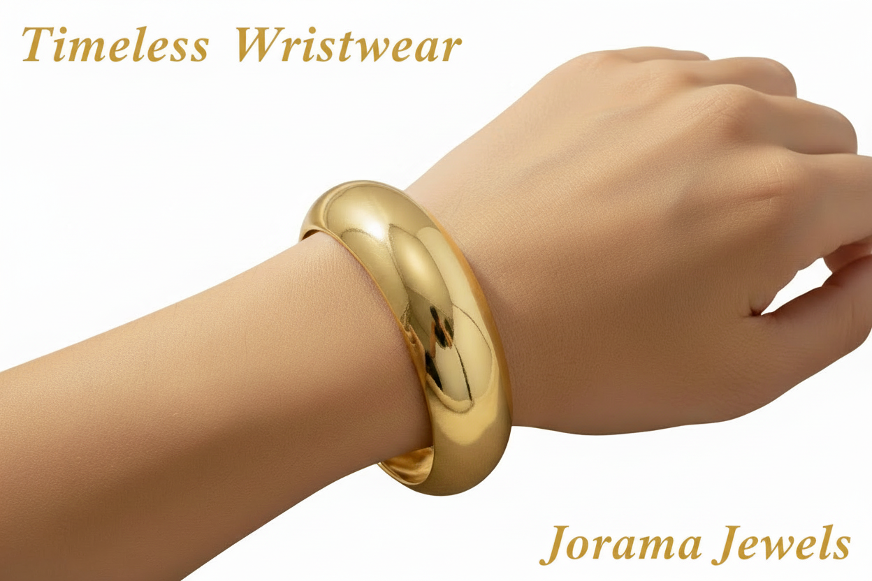 Gold bracelet on a wrist against a beige fabric background