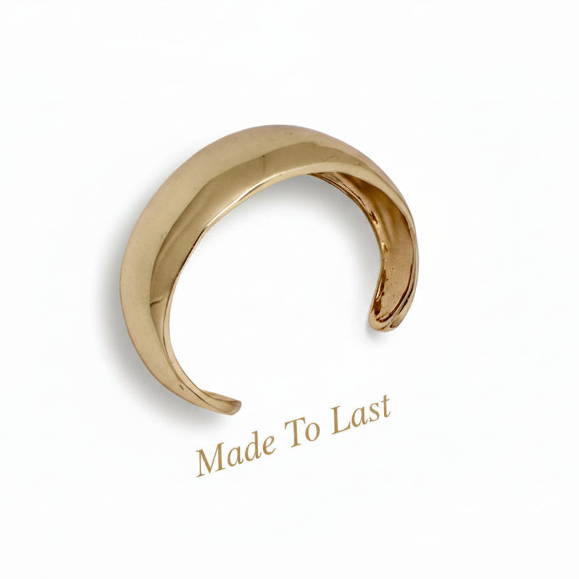 Metal cuff bracelet on a white background