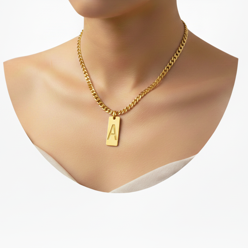 Gold necklace with a small pendant on a neck against a white background